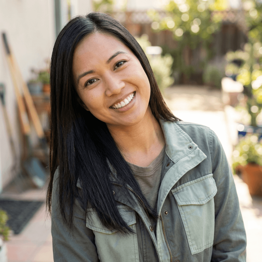 Sarah Thompson, a farm manager, smiling in her store's produce section
